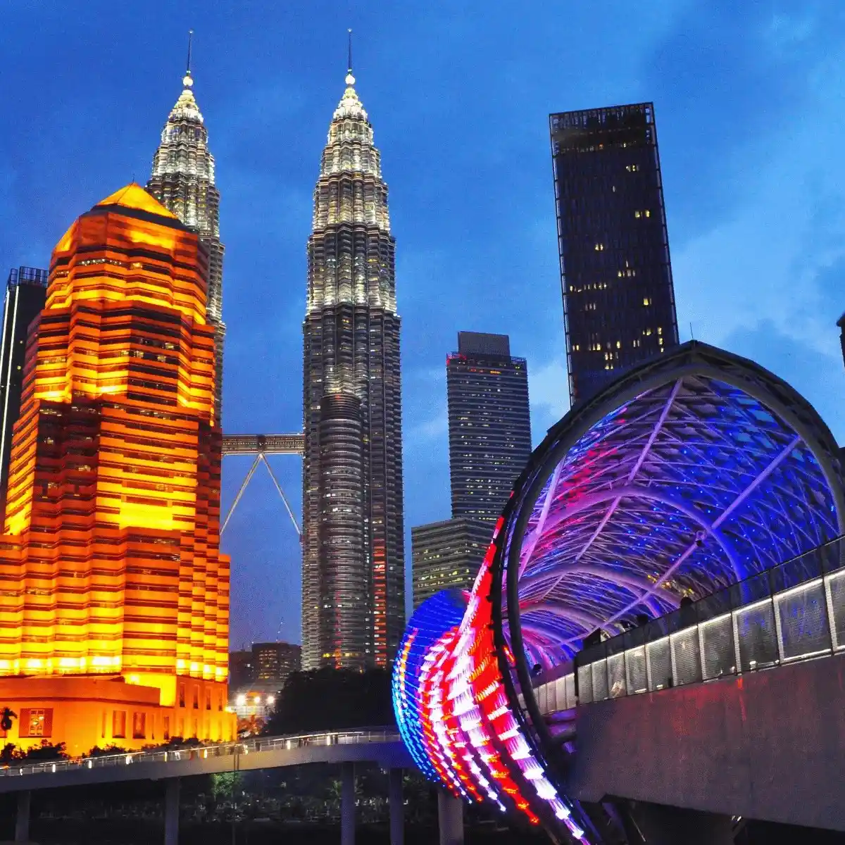 Petronas Towers and city lights of Kuala Lumpur at night.