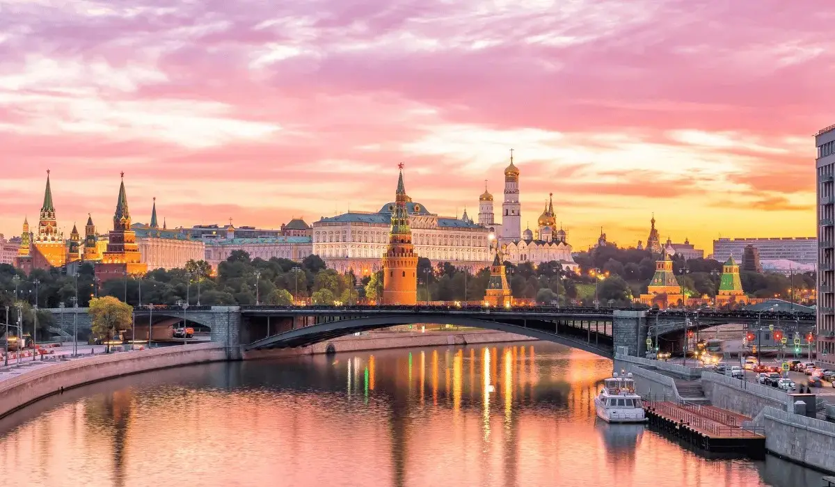 Moscow Kremlin and Red Square at sunset, reflecting over the Moskva River.