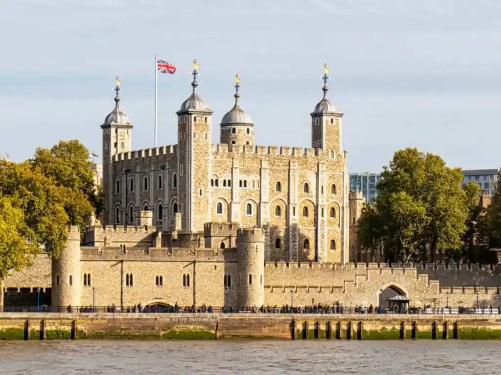 Tower of London fortress with Union Jack flag and riverfront