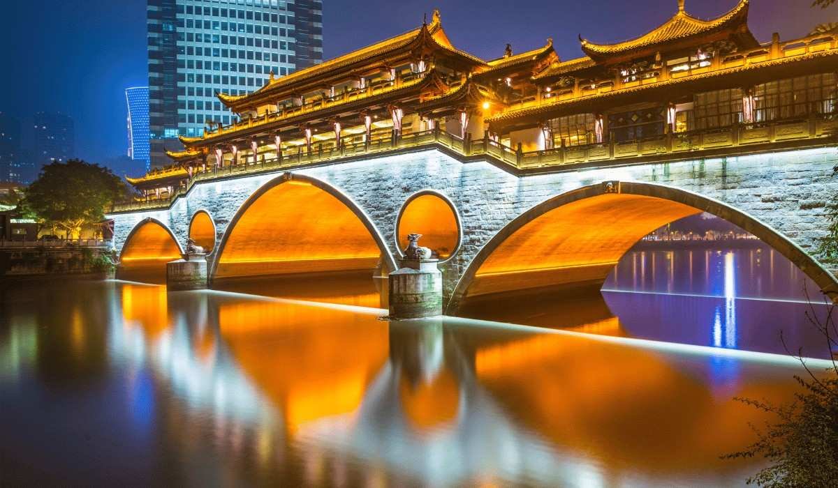 Illuminated Anshun Bridge over Jin River at night in Chengdu, China.